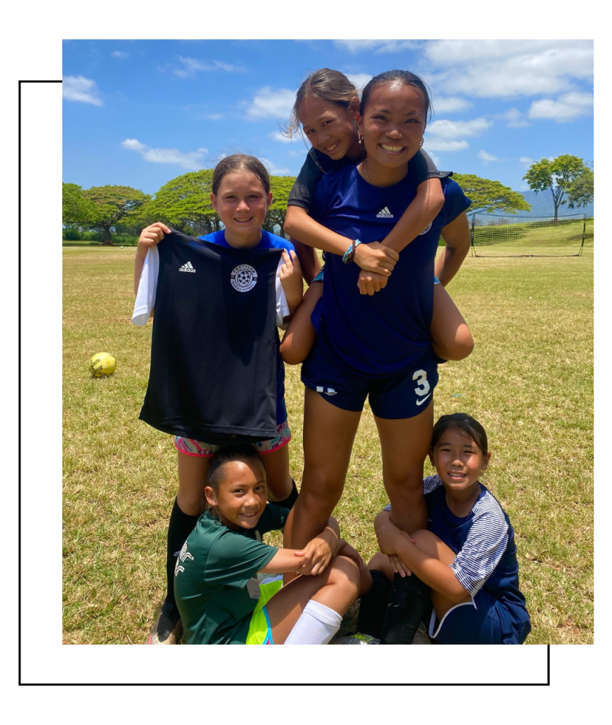 Footy Lab players standing around Coach Kayla in a team session