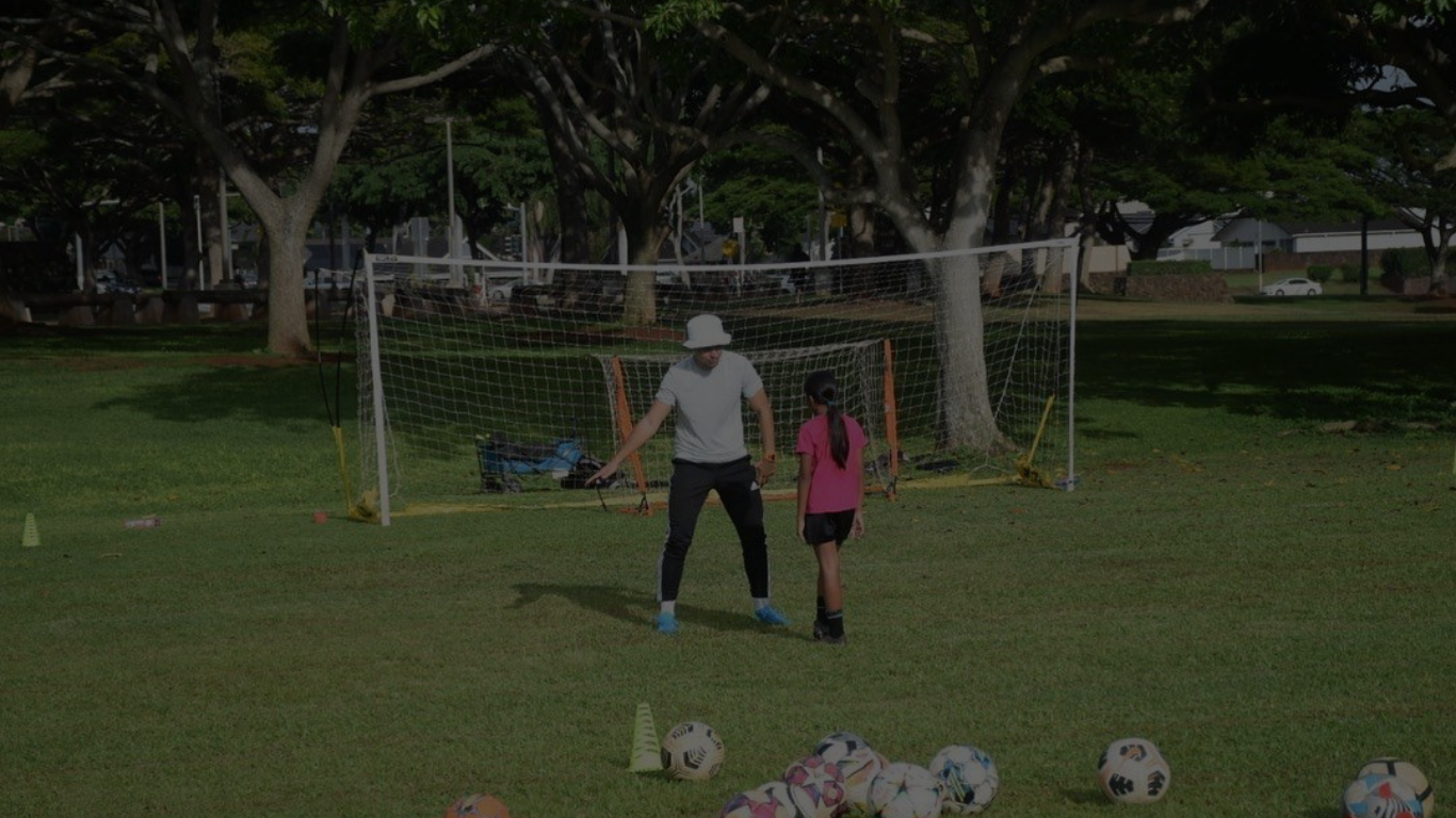A young soccer player doing a 1 on 1 session with Coach Micah
